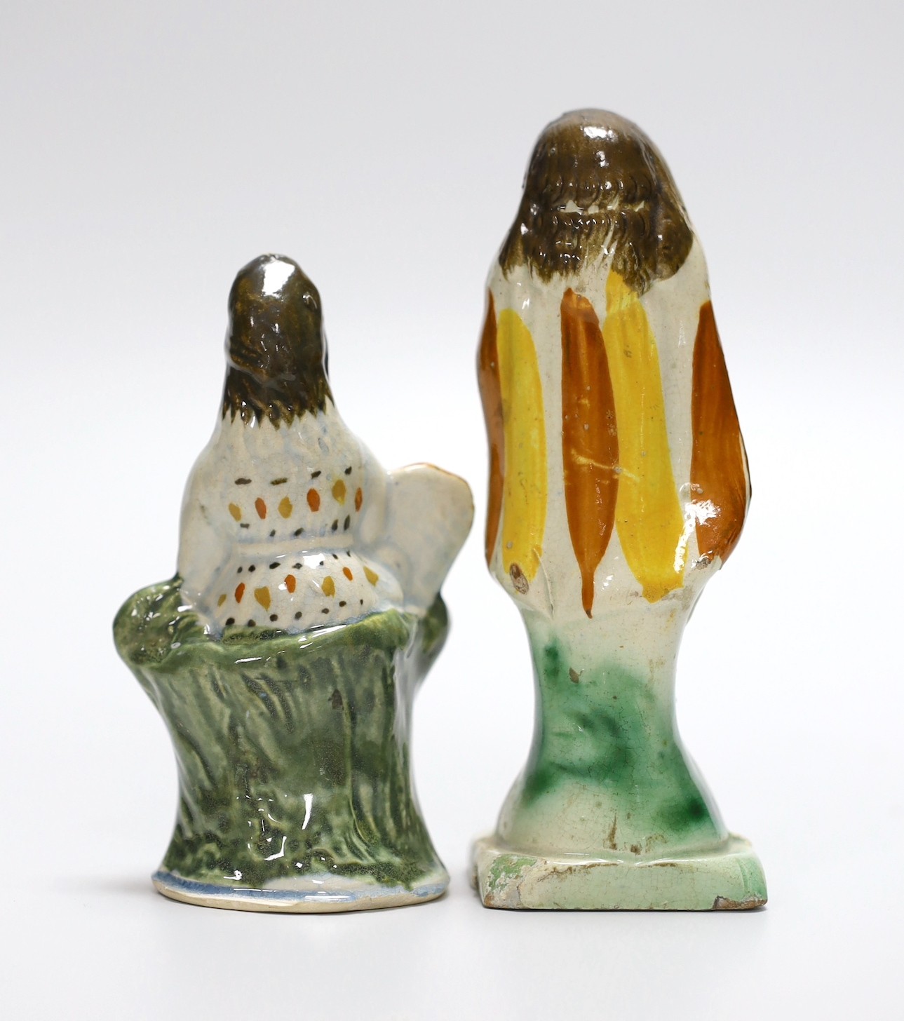 Two Georgian slip-cast Prattware figures and a Victorian salt glazed stoneware novelty pistol liquor flask, 24cm (3)